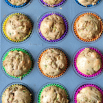 Zucchini muffins in a 12-tin with brightly colored liners
