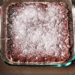 perfectly baked brownies with powdered sugar on top