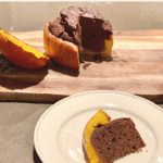 A slice of delicious chocolate cake within a baked pumpkin